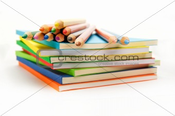 pencils on the surface of stack of books