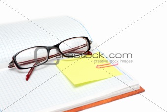Spectacles on note pad