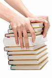 Feminine hands keeps pile of the books