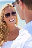 Attractive Man and Woman Couple In Sunglasses At Beach