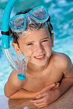 Happy Boy In A Swimming Pool with Goggles and Snorkel