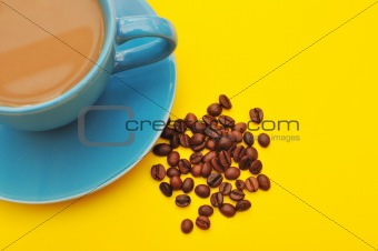 blue cup of coffee with coffee grain 