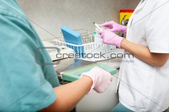 Dentist and female assistant with medical tools
