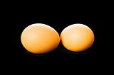Two eggs isolated on the black background