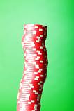 Stack of red casino chips against green background