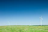 group of wind turbines on green field