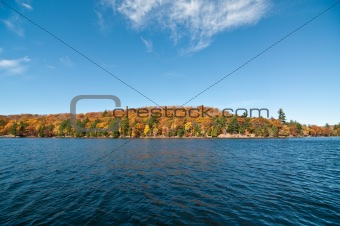 Canadian Lake with Autumn Colours and Blue Sky