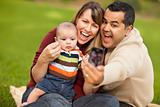 Happy Mixed Race Parents and Baby Boy Taking Self Portraits at the Park.
