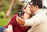Attractive Mixed Race Couple Taking Self Portraits in the Park.