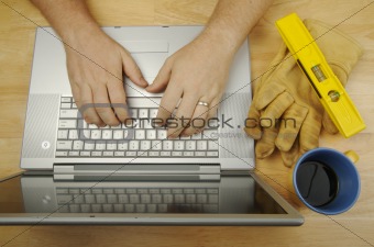 Contractor Reviews Project on Laptop