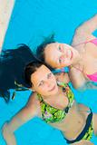 Two beautiul girls in a swimming pool 