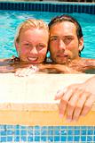 attractive couple relaxing by the pool