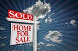 Sold Home For Sale Sign on Blue Sky and Burst