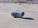 Floating rock on sand
