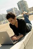 Young man using laptop outdoor