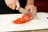 Slicing tomato with knife
