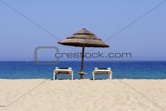 sun lounger on sandy beach, corsica, mediterranean