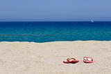 flip flops on empty sandy beach, corsica