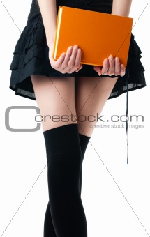 woman in skirt and stockings with book