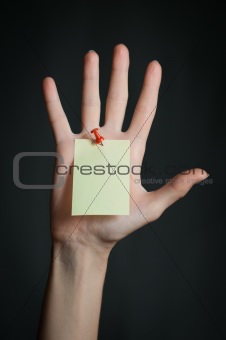 female hand with blank note