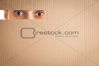 woman looking through the hole in cardboard