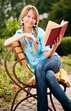 beautiful young student girl reading book