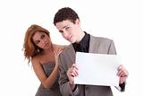 young couple, man holding  a paperboard in hand,she looking for him, isolated on white, studio shot