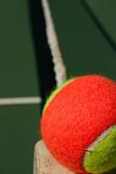 Tennis ball on the edge of the net