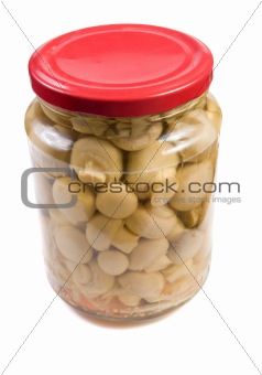 Marinaded mushrooms in a glass jar . 