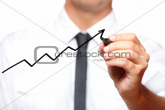 Businessman drawing an arrow going up