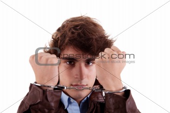 Arms on the face, of a young man, with a handcuffs on the hands, isolated on white background
