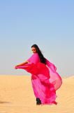 Beautiful young woman  dancing in arabic desert