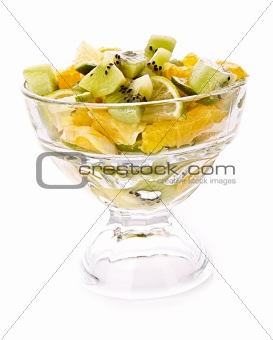 Cup with orange, kiwi and lime isolated on white