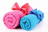 Twisted blue and pink towels with bands isolated on white