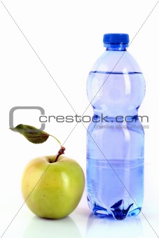 Bottle of sparkling water and green apple isolated on white