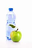 Bottle of sparkling water and green apple isolated on white