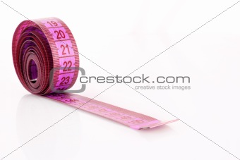 Twisted pink measuring  tape isolated on white