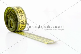 Twisted yellow measuring  tape isolated on white
