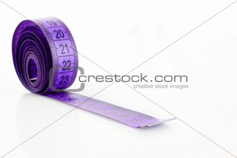 Twisted purple measuring  tape isolated on white