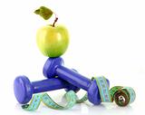 Dumbbells, green apple and measuring tape  isolaeted on white