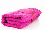 Folded pink towel with the band isolated on white