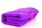 Folded purple towel with the band isolated on white