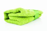 Folded green towel with the band isolated on white