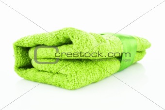 Folded green towel with the band isolated on white