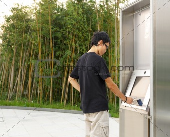 man using touch screen outdoor