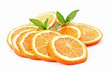 Many sliced oranges and green plant isolated on white