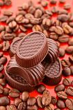Chocolate and coffee beans on red background