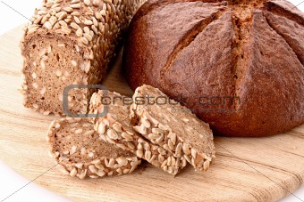 Bread on wooden plate isolated on white