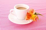 Cup of coffee and flower on red background