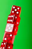 Red dice stack against blurred green background